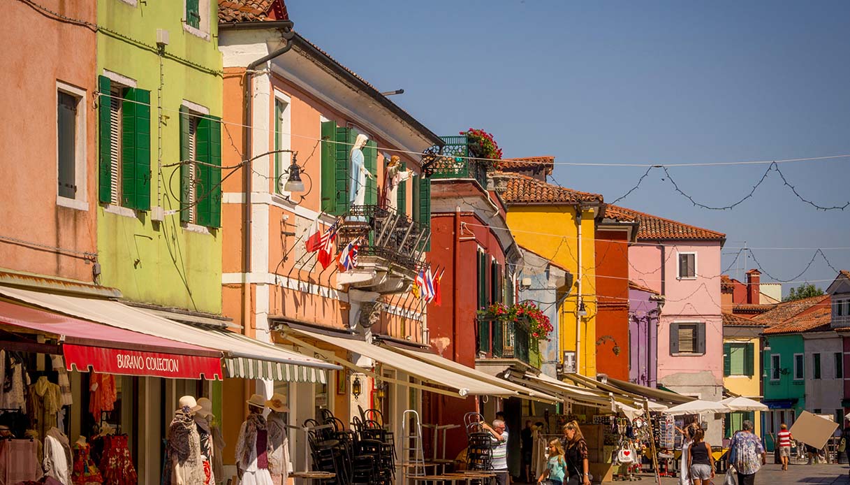The traditional colourful painted shop exteriors on the island of Burano. Venice, Italy.